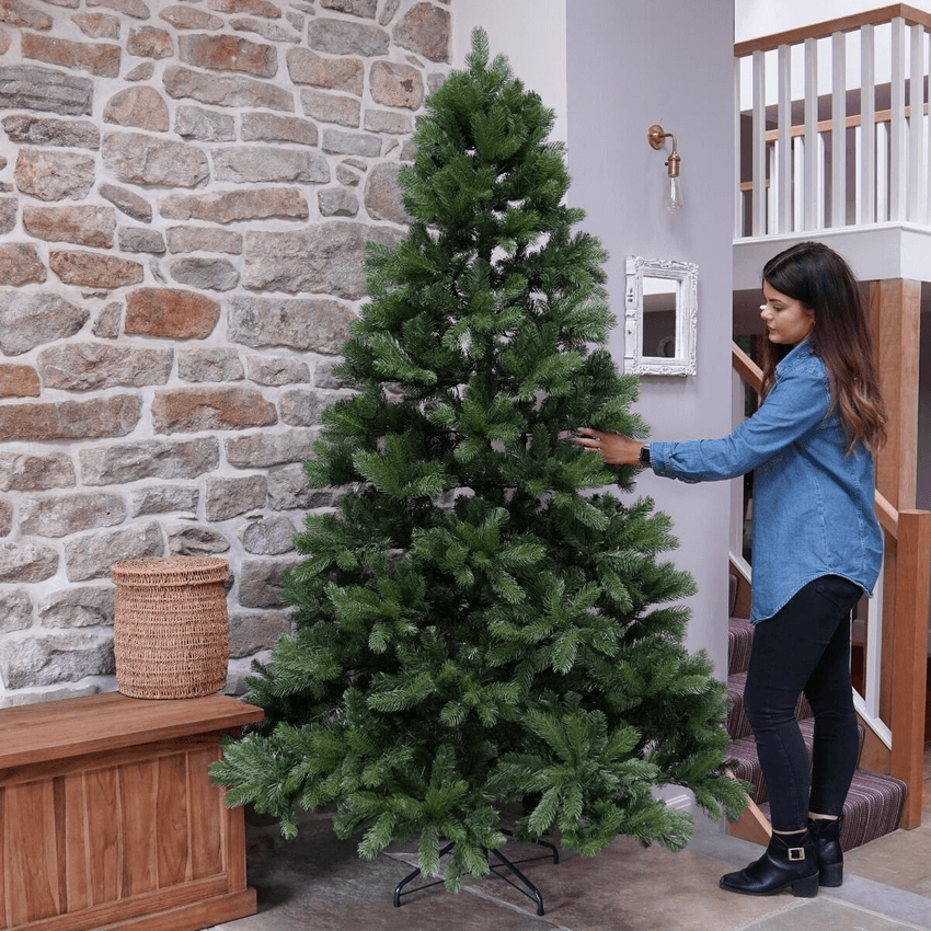 Mayberry Spruce 7 Ft Christmas Tree women decorating Christmas tree