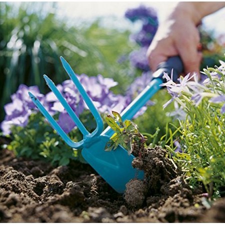 Gardena Combisystem Hand Hoe man raking dirt